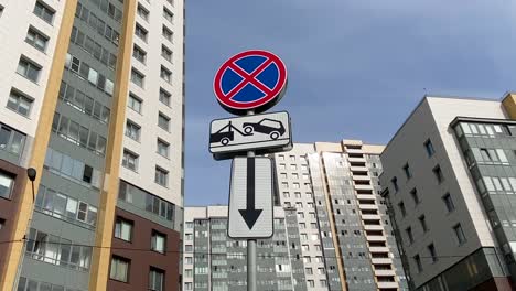 road sign parking prohibited evacuation on the background of modern apartments buildings. modern residential quarter. no parking!