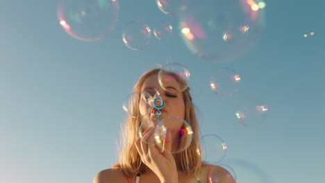 happy-young-woman-blowing-bubbles-on-beach-at-sunset-enjoying-summer-having-fun-on-vacation-by-the-sea