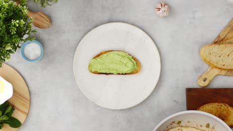 faceless person preparing chicken and avocado toast in kitchen