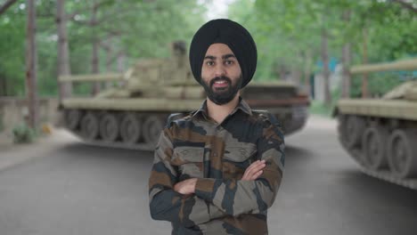 happy sikh indian army man standing crossed hands