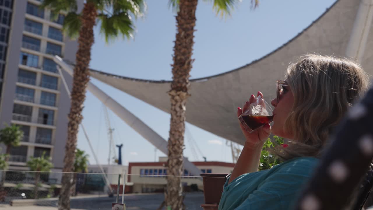 Woman Enjoying Her Drink While Sitting At The Cafe. - closeup shot