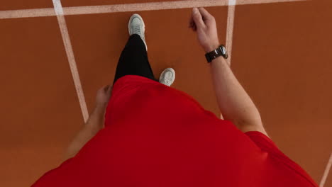 first-person view of a person running on an athletic track