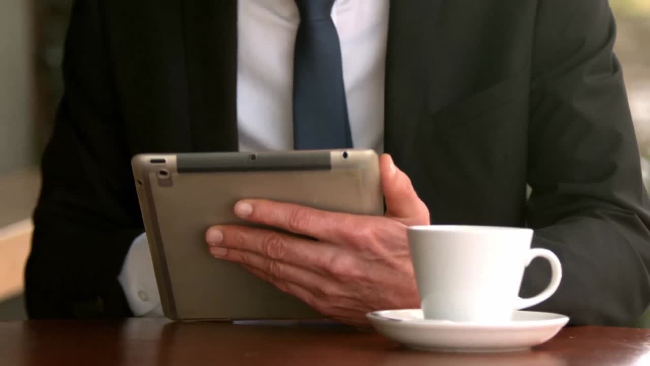 Handsome businessman using his tablet
