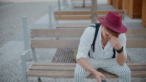 man sitting on a bench, looking depressed