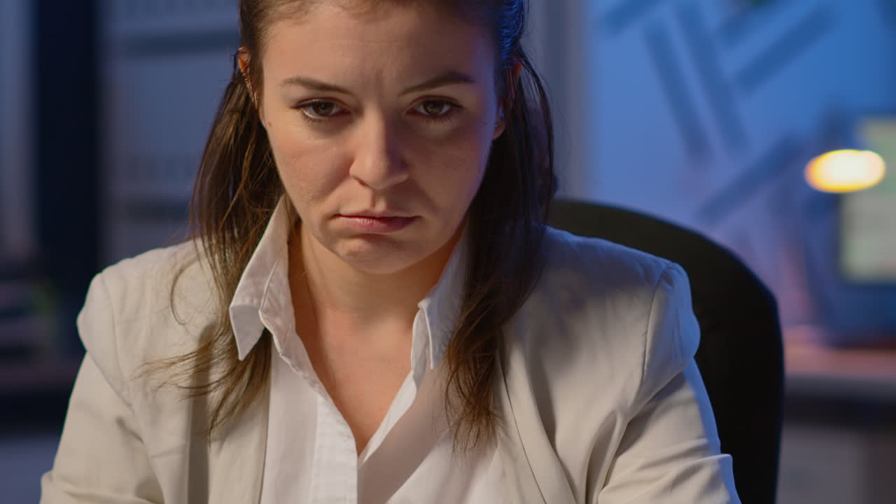 Close up of exhausted manager working overtime to respect deadline