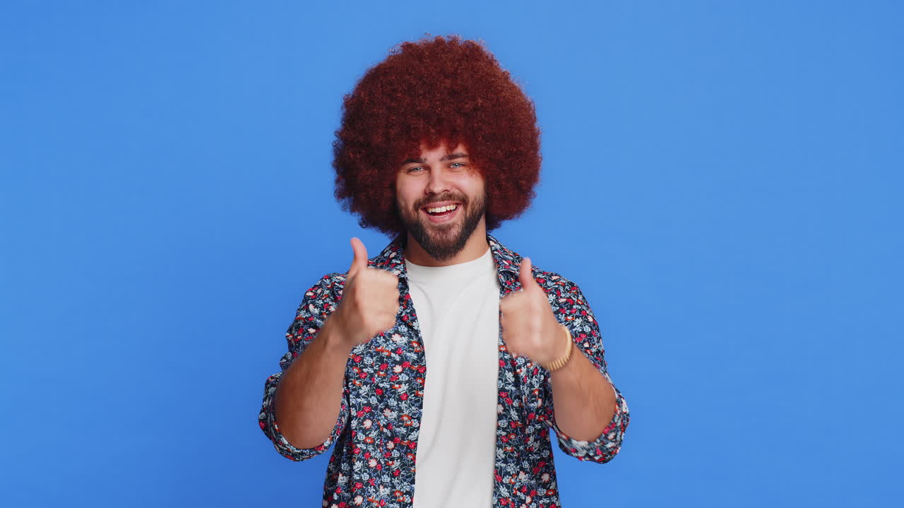 Caucasian man raises thumbs up agrees gives positive reply recommends advertisement likes good idea