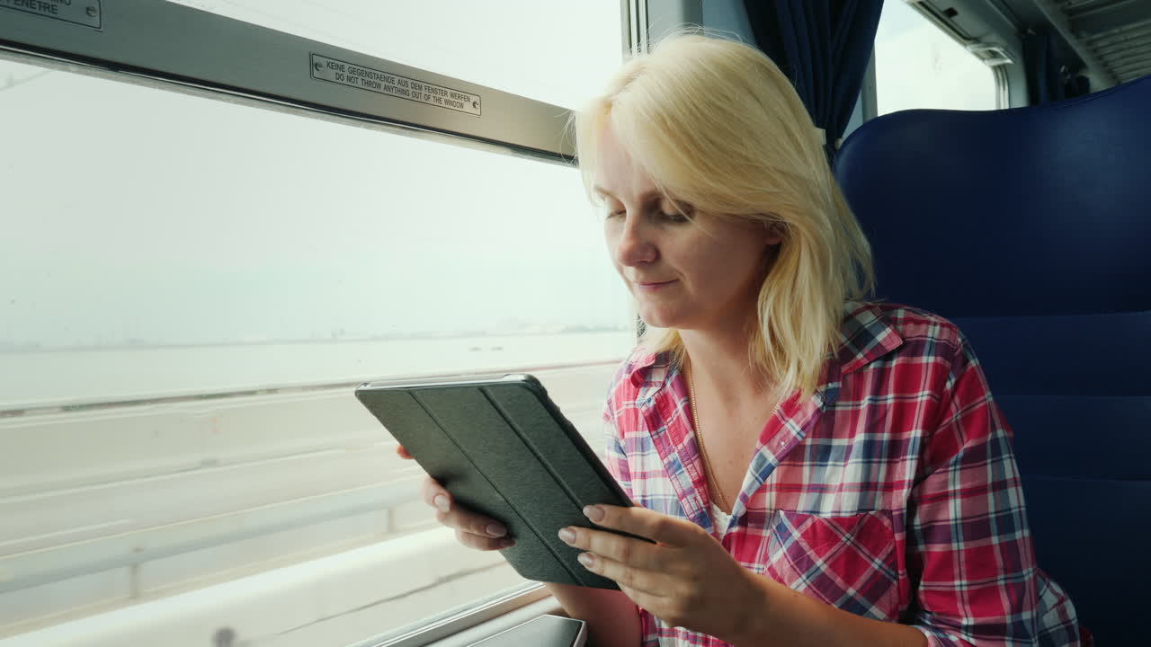 Woman On A Train Using a Tablet