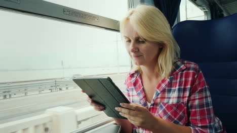 mujer en un tren usando una tableta