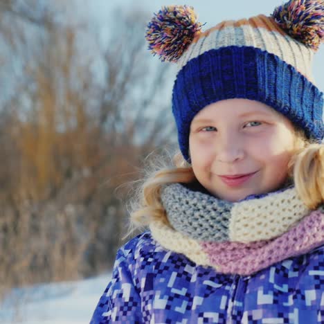 portrait of a girl who throws the snow and laughs