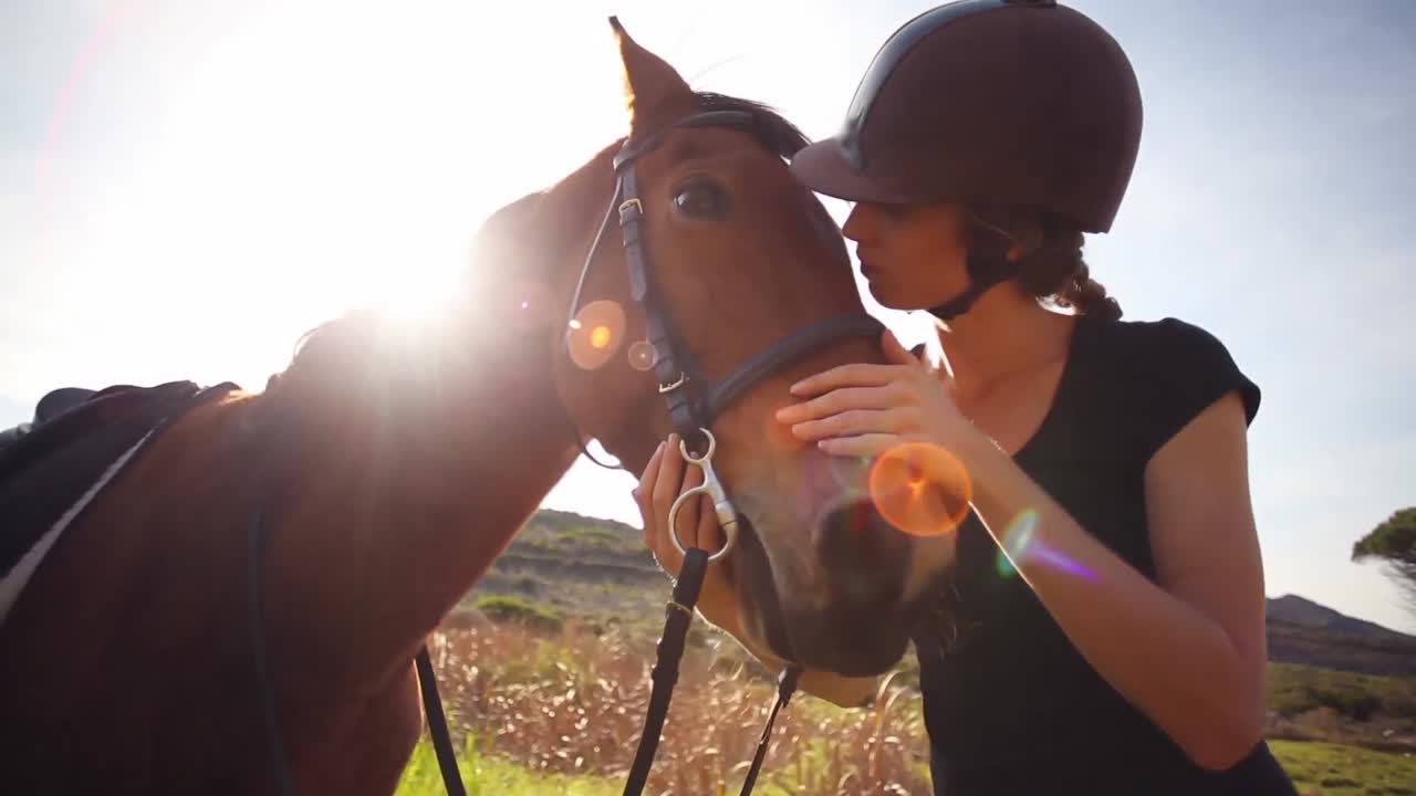 Pretty woman standing next to horse