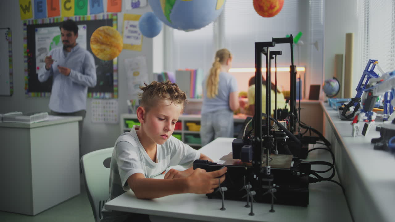 Elementary School Boy Using 3D Printer Control Panel Learning Automated 3D Printing