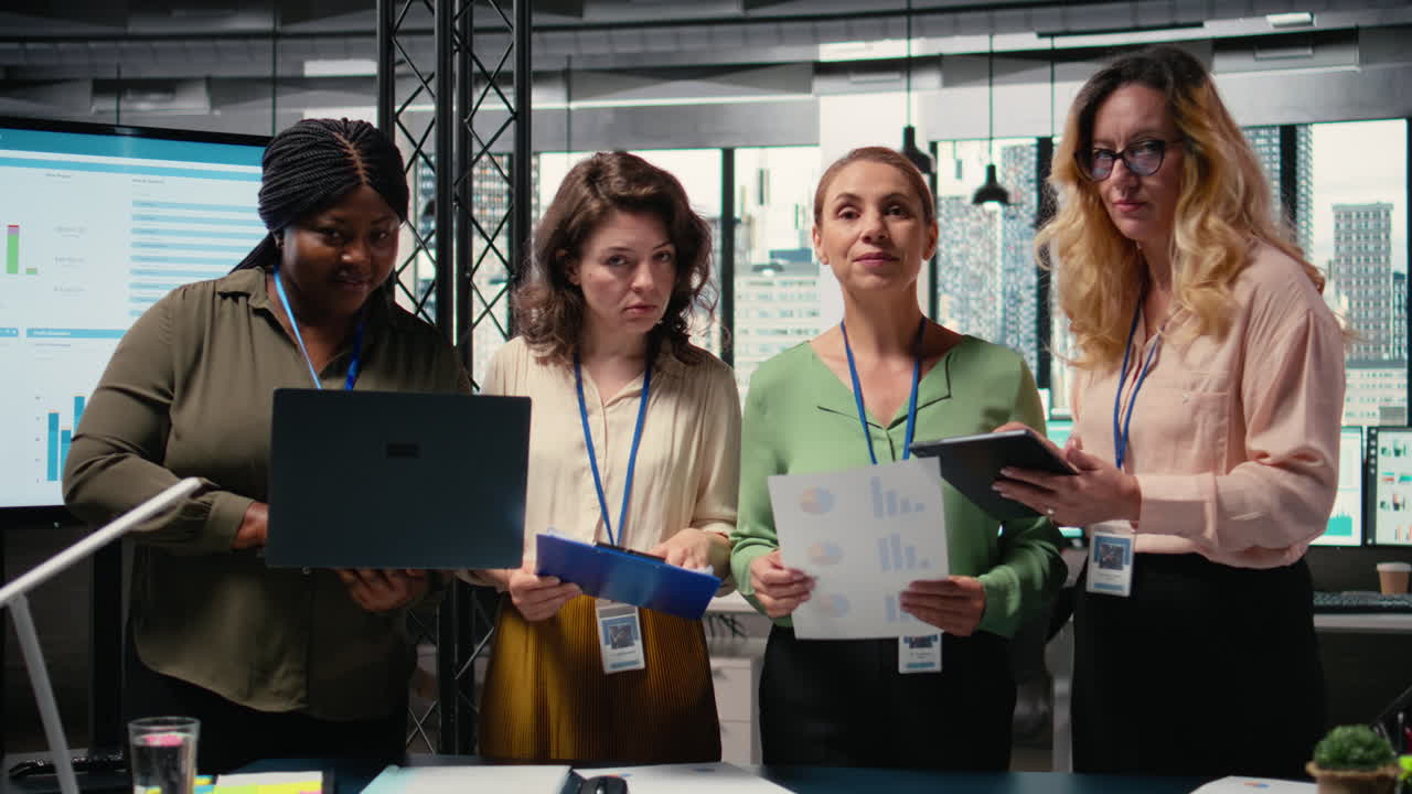 Vertical Video Group of empowered businesswomen collaborate in a modern office