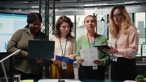 vertical video group of empowered businesswomen collaborate in a modern office