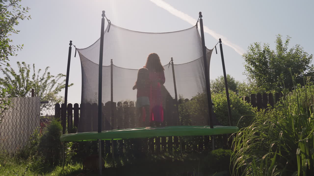 White Girl Sitting Inside Trampoline Silhouette, Backlit By Bright Sunflare, Calm Reflective Posture, Garden Fence And Lush Greenery Framing Scene, Soft Afternoon Light, Peaceful Solitude