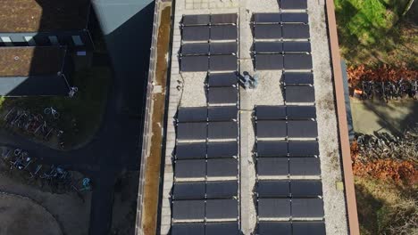 dolly over solar panels on top of apartment building on a sunny day