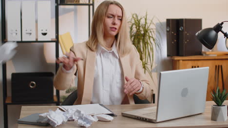 Angry-furious-woman-working-at-home-office-throwing-crumpled-paper,-having-nervous-breakdown-at-work