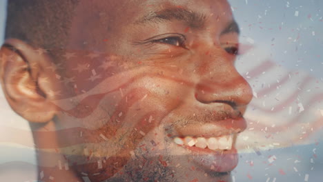 animación de la bandera de los estados unidos de américa y confeti sobre un hombre afroamericano en la playa