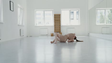 woman practicing yoga and stretching in a studio