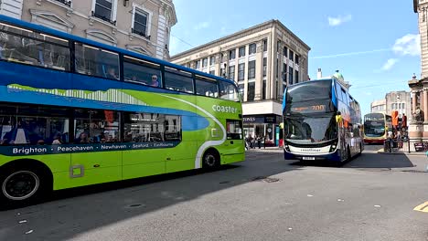 double-decker buses maneuver through busy brighton intersection