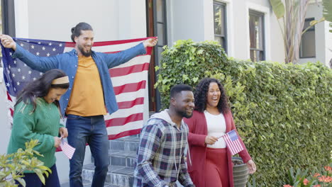 happy diverse friends with flags welcoming home male soldier friend