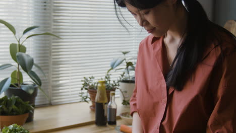 woman chopping vegetables in kitchen