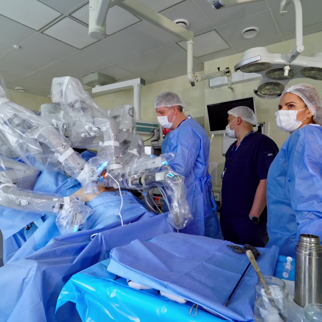 Minimal invasive robot surgical system. Surgical team operating patient in theater