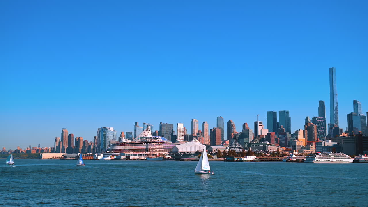 New York, USA, 9 August 2025: Sailboats and cruise ships in front of Manhattan skyline. Several sailboats and large cruise ships float on the Hudson River with the Manhattan skyline in the background