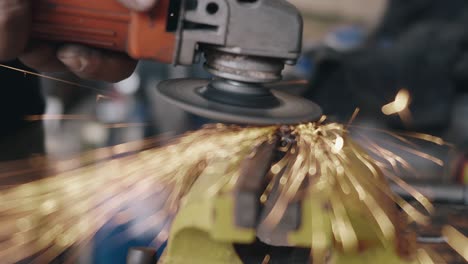 worker man using electric wheel tool grinding and cutting on steel structure