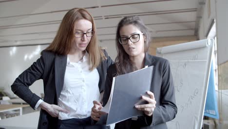 focused businesswomen working with papers