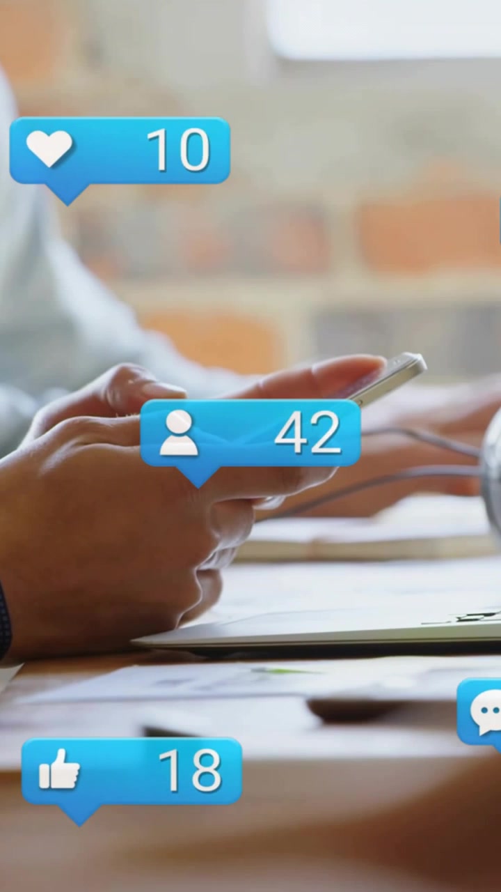 Vertical video: Hands tapping phone at shared desk starting animated bubbles showing marketing rise