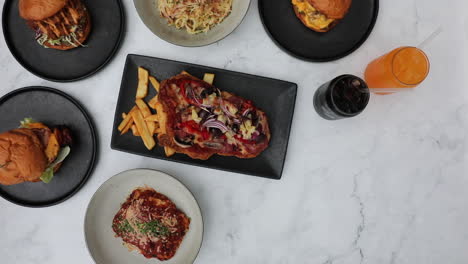 male hands putting down delicious bowl of hot wedges onto table setting