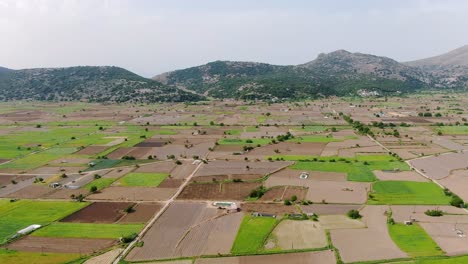 Drone-flight-with-boundless-agricultural-empty-lands-Spinalonga,-Crete,-Greece