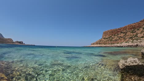 sunlight reflections on the rocky bottom of balos beach crystal clear. - underwater shot