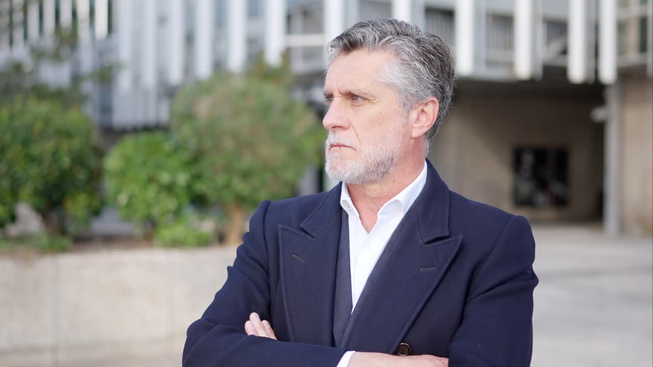 Portrait of a mature businessman with crossed arms outdoors