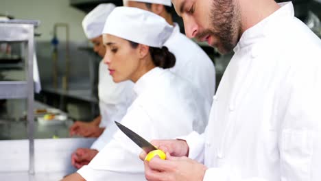 team of chefs chopping vegetables and preparing food