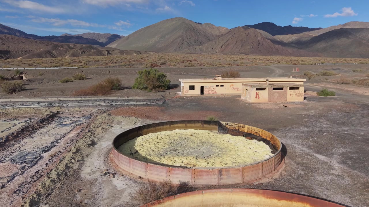 Drone flyby dolly of circular settling tanks at abandoned aluminum sulfate plant, Calingasta, drone