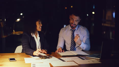 businesspeople celebrating after working late to