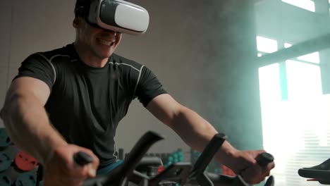 a man performs a heavy exercise on a bicycle simulator in a vr helmet