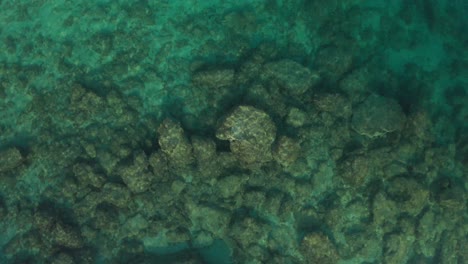 Top-down-shot-of-a-beautiful-small-lagoon-at-Cape-Kamenjak,-Croatia