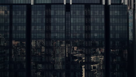 skyline building glass wall facade reflecting city highrise buildings, klcc skylines, kuala lumpur, aerial closeup