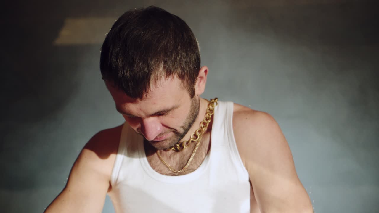 a gangster with handcuffs on his hands is trying to free himself. Drug crime