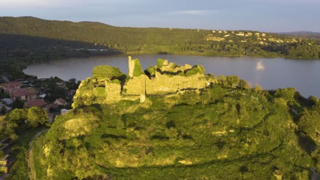 drone flies over orsinis fortress in trevignano, lazio, italy