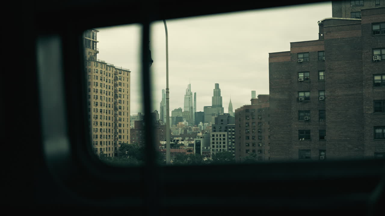 View of New York City Skyline and Urban Buildings from a Moving Window