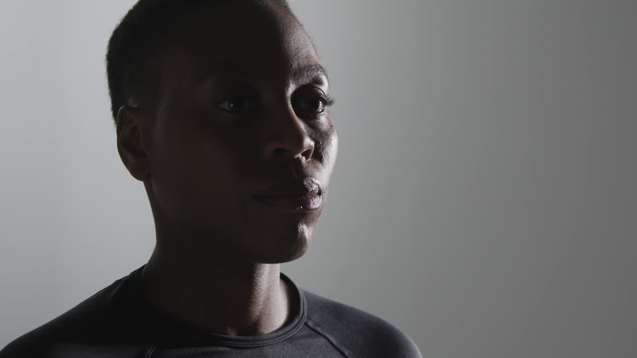 Close Up Studio Shot Of Woman Wearing Gym Fitness Clothing Drinking Water After Exercise