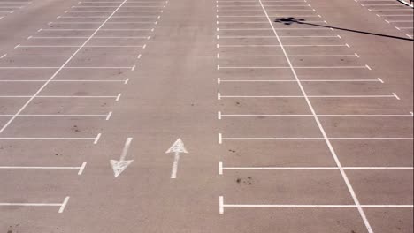 empty parking lot with directional arrows