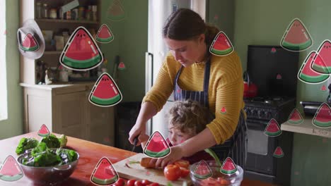 Animation-of-watermelon-icons-over-caucasian-woman-with-son-cooking