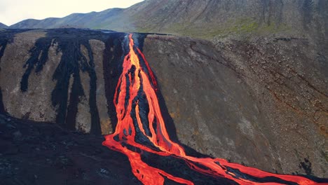 flying towards a lava stream flowing down the hill from fagradalsfjall volcano in iceland