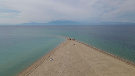 4k-taking-off-clip-over-a-peninsula-on-the-tropical-beach-of-Epanomi,-Halkidiki,-Greece