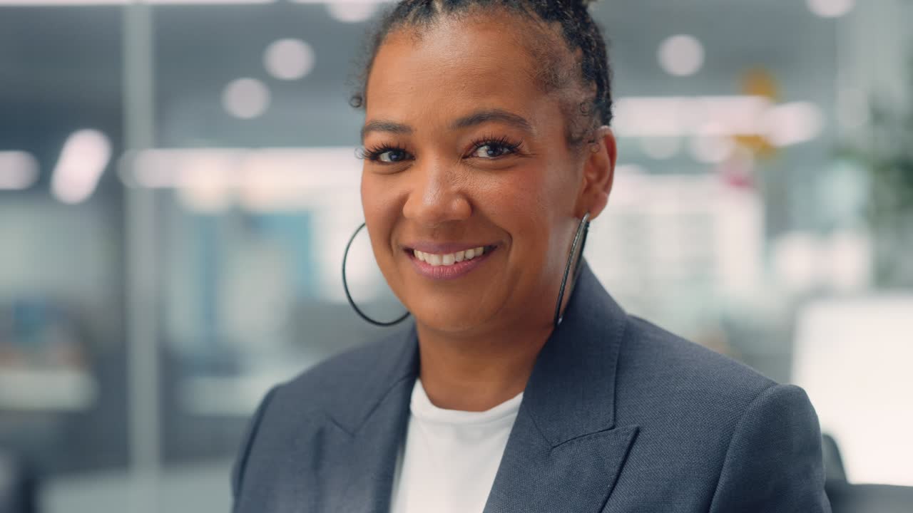 Portrait of a Confident Happy Adult Middle Aged African American Female Wearing Dark Jacket, Looking at Camera, Posing and Charmingly Smiling. Successful Black Woman Working in Diverse Company Office.