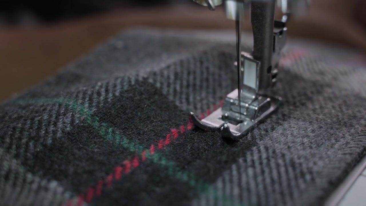 Man Stitching Clothes Using an Electric Sewing Machine